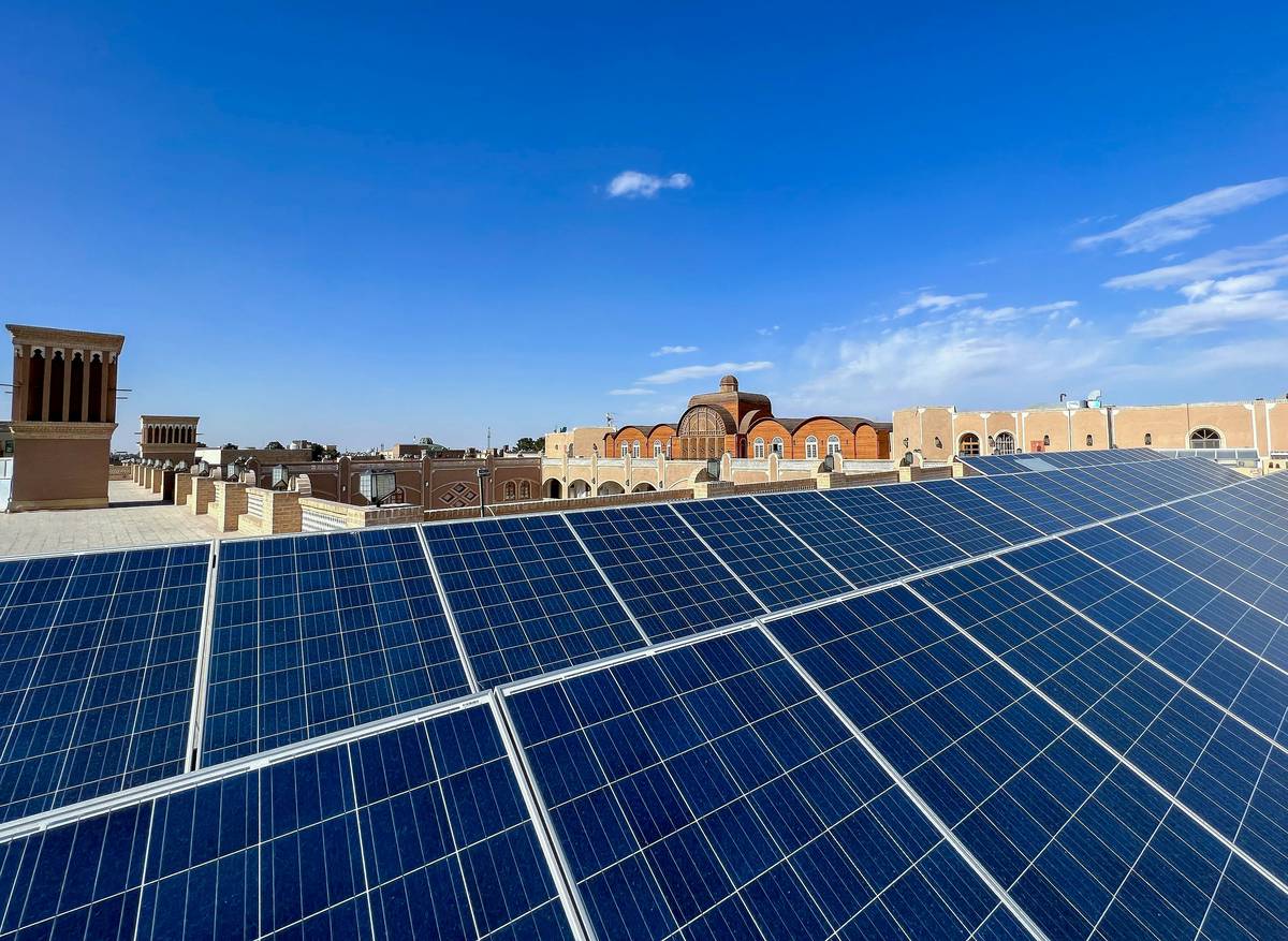 solar energy definition illustrated with rooftop panels connected to a home inverter system